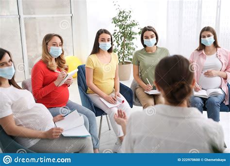 Group Of Pregnant Women And Midwife In Masks At Courses For Expectant Mothers Indoors Stock