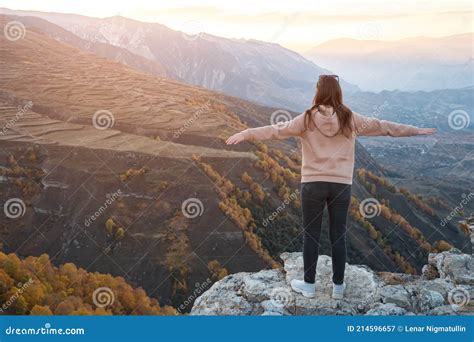 Young Woman With Loose Flowing Hair Stands On Grey Hilltop Stock Image