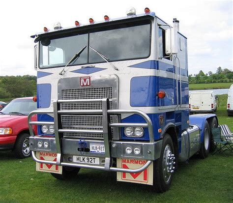 Blue And White Marmon Truck In A Lush Green Field