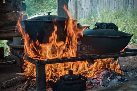 cook food on burning campfire cooking on an open fire outdoor cooking outdoor food stock