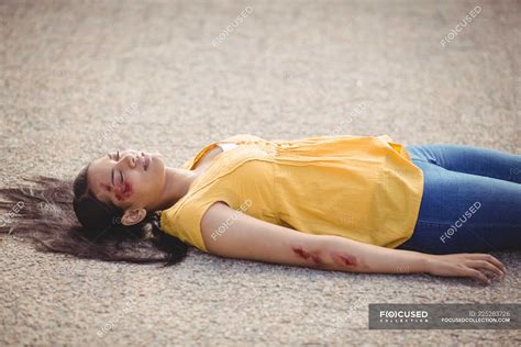 Close Up Of Unconscious Woman Fallen On Ground After Accident — Female Casual Clothing Stock