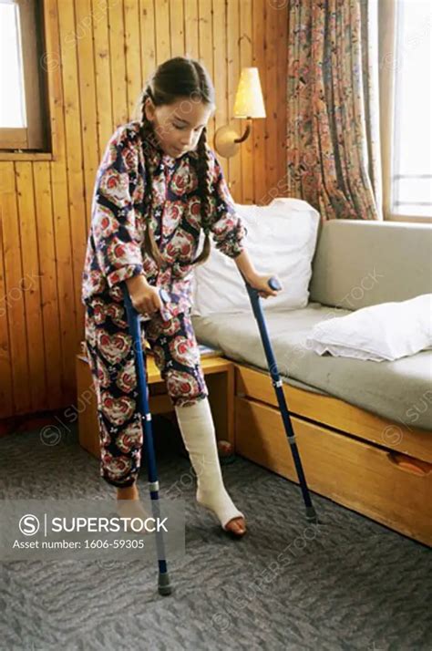 Little Girl Brocken Leg Walking With Crutches Superstock