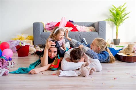 Tired Parents And Romping Kids Stock Image Image Of Indoor Mess