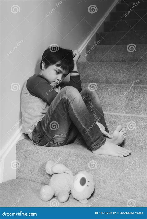 Sad Asian Boy Wearing Sitting On Carpet Staircase In The Morning