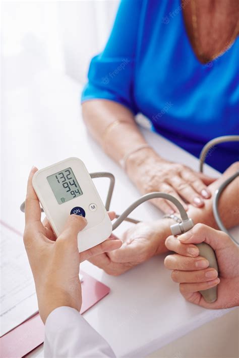 Premium Photo General Practitioner Checking Blood Pressure
