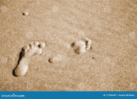 A Pair Of Footprints In Wet Sand Royalty Free Stock Photo