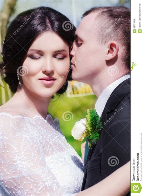 Groom And Bride In A White Dress In The Spring Garden Stock Image Image Of Laughing Ethnicity