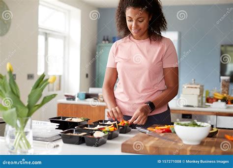 Woman Preparing Batch Of Healthy Meals At Home In Kitchen Stock Photo