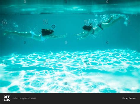 Two Girls Swim Towards Each Other In A Pool Stock Photo Offset