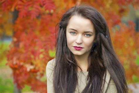 Young Beautiful Brunette Woman Posing Outdoors In Autumn Park Stock