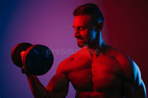 Close Photo Of A Muscular Man Who Is Doing Bicep Curls Under Blue And