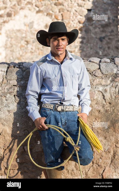 A Mexican Charro Or Cowboy Poses In Cowboy Hat And Lasso At A Hacienda