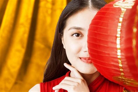 premium photo asian chinese woman in a cheongsam dress holding chinese lantern happy chinese