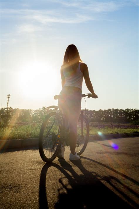 Girl Riding A Bike At Sunset Photo Free Download