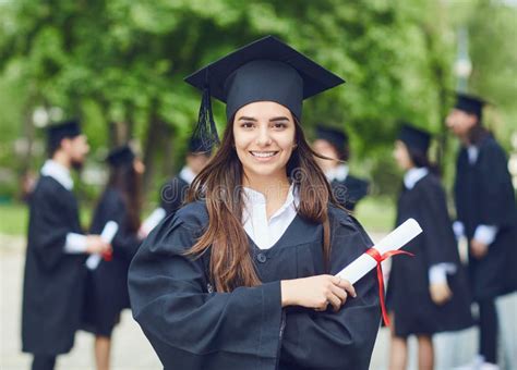 A Young Female Graduate Against The Background Of University Graduates