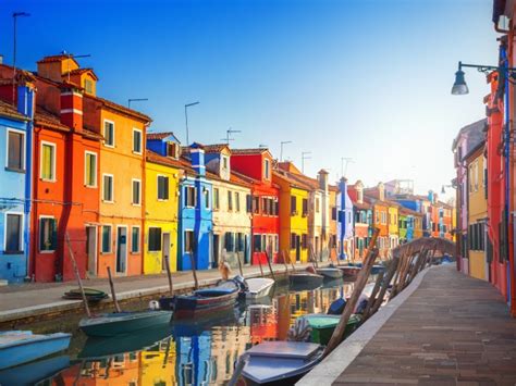 Multi Colored Houses By The Water Channel With Boats Italy Wallpapers