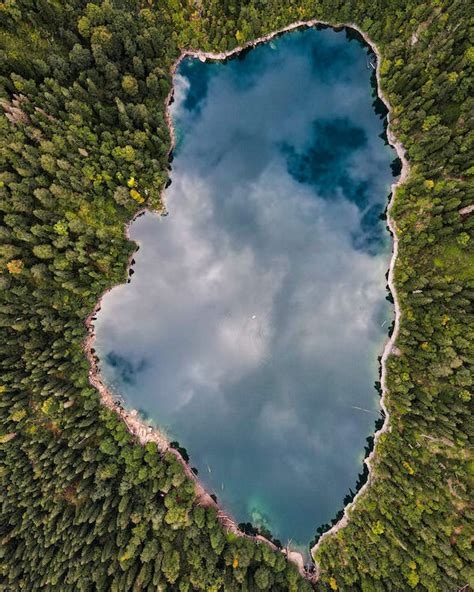 An Above Shot Of A Lake In Forest With A Reflection Of Sky In It · Free