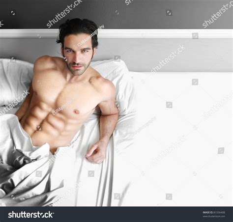 Portrait Of A Young Man Laying In Bed With Copy Space