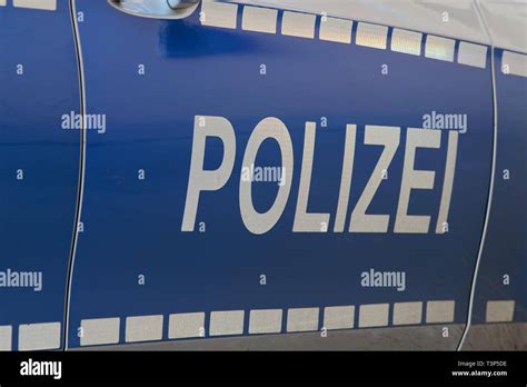 Side View Of A Typical German Police Car With Lettering Polizei On Blue Background Hamburg