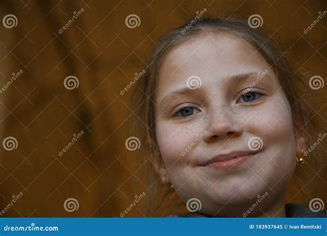 Portrait Of A Little Young Cute Smiling Girl Close Upoutdoor Stock