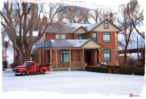 A Red Truck Is Parked In Front Of A House With Snow On The Ground And Trees