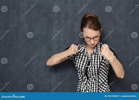 Portrait Of Angry Dissatisfied Girl Holding Fists In Front Of Her Stock