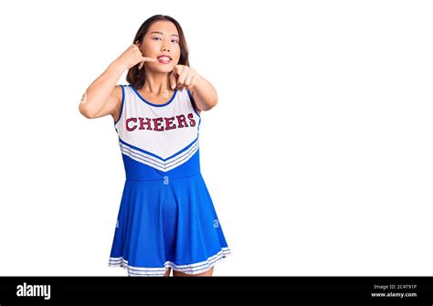 Young Beautiful Chinese Girl Wearing Cheerleader Uniform Smiling Doing