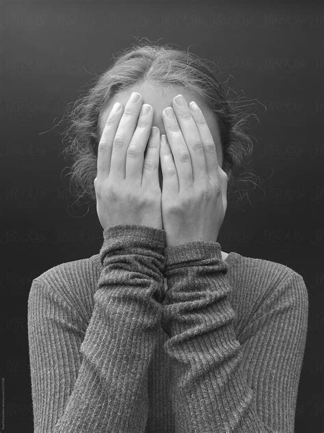 Portrait Of Teenage Girl With Hands Covering Face Close Up By