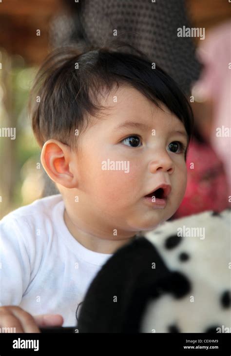 Chinese Eurasian Baby In Close Up Looks On The Side His Mouth Is Open