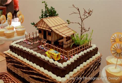 There Is A Cake That Looks Like A Small House On Top Of A Table With