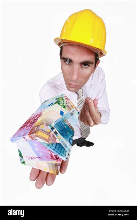 Architect With A House Made Of Money Stock Photo Alamy