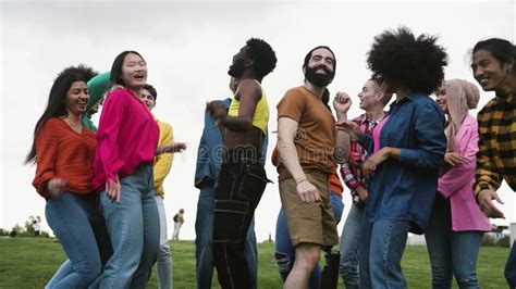 Young Multiracial Friends Having Fun Dancing Together In Park Stock