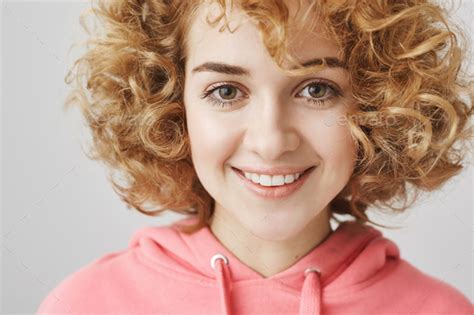 Close Up Portrait Of Charming Sunny Girl With Fair Curly Hair Smiling