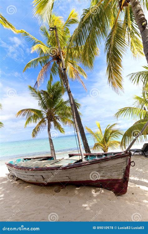 Old Wooden Fishing Boat On A Tropical Paradise Island With Coconut Palm