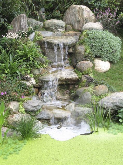 A Three Tiered Stone Waterfall That Ends In A Tiny But Deep Well The Ground Surrounding It Is