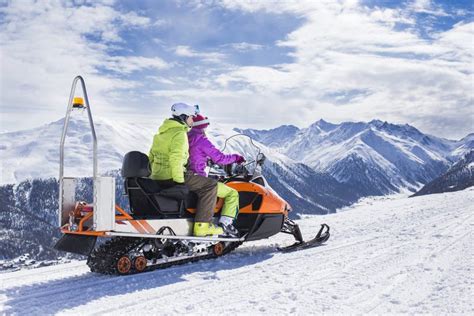 Young Couple Riding Snowmobile Snow Mountain Road Stock Photo Image