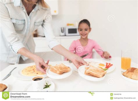 mom gives her daughter breakfast they are in the bright kitchen stock image image of bright