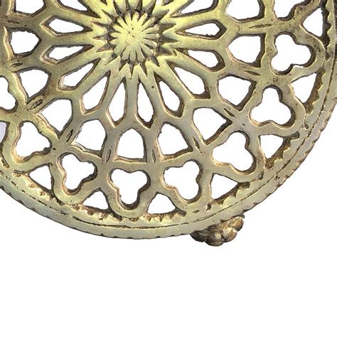 brass trivet with quatrefoil detail and clawfoot legs at 1stdibs