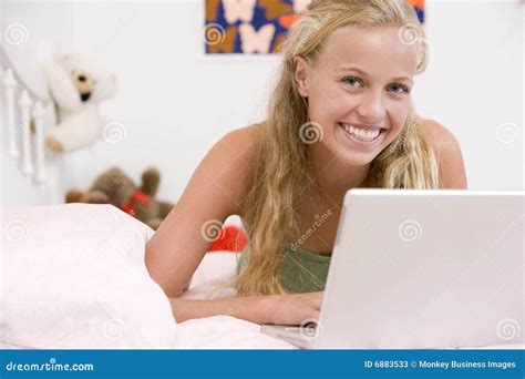 Teenage Girl Lying On Her Bed Using Laptop Stock Image Image Of Horizontal Inside 6883533