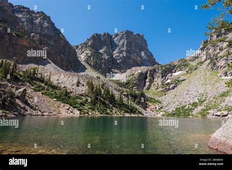 Landscape Of Jagged Mountain Peaks And Emerald Lake In Rocky Mountain