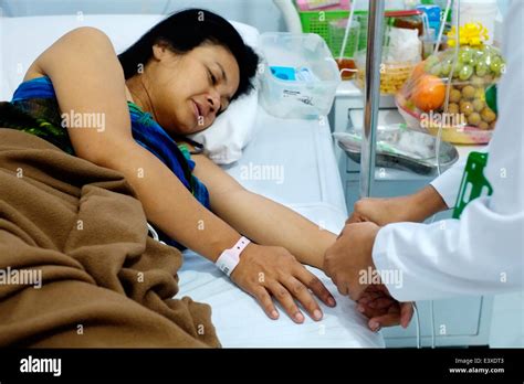 An Indonesian Woman Has Her Pulse Checked By A Nurse After An Operation In A Hospital In Malang