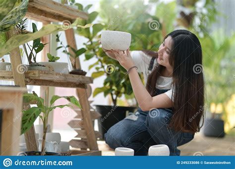 Young Woman Caring For Trees Planting And Caring Equipment Plants In