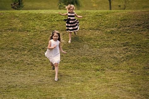 Girls Run From Hill On Green Grass On Summer Day Stock Image Image Of