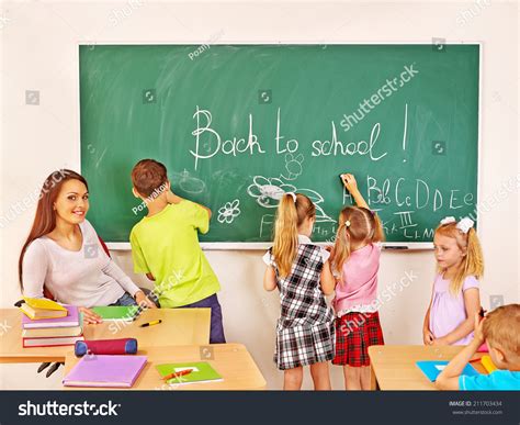 Children Writing On Blackboard At School Stock Photo 211703434