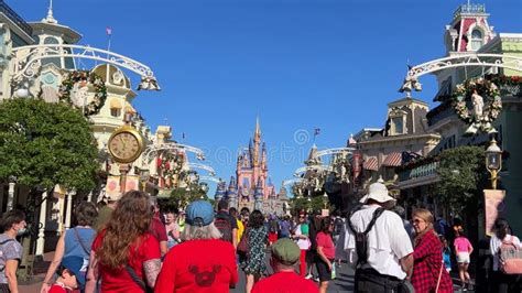 People Walking Down Main Street Usa In The Magic Kingdom At Disney