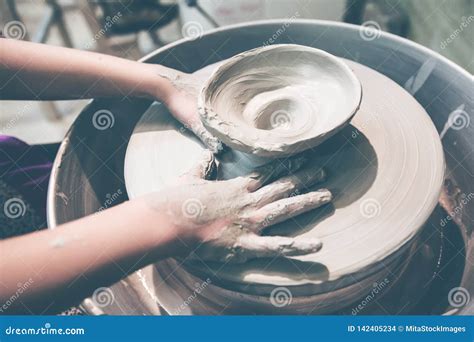 Young Potter Hands Working With Clay On Pottery Wheel Stock Photo
