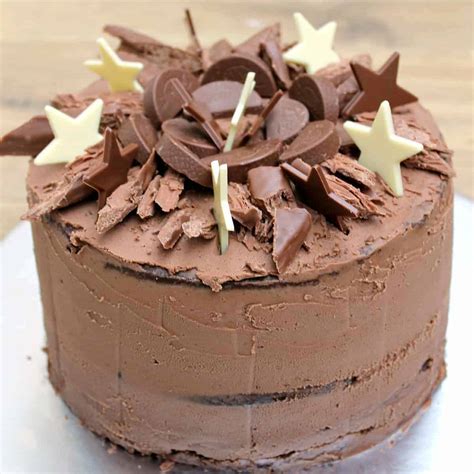 Adorable kids sitting at table, cheering and waiting for cake during birthday party. Chocolate Birthday Cake - BakingQueen74