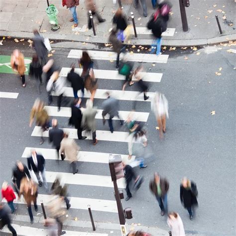 Aerial View Of A Crowd Of People Crossing A City Street At A Pedestrian