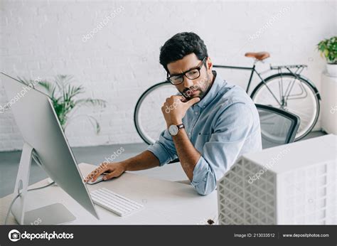 Serious Handsome Architect Using Computer Looking Architecture Model