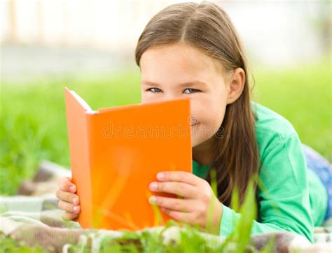 Little Girl Is Reading A Book Outdoors Stock Image Image Of Happy